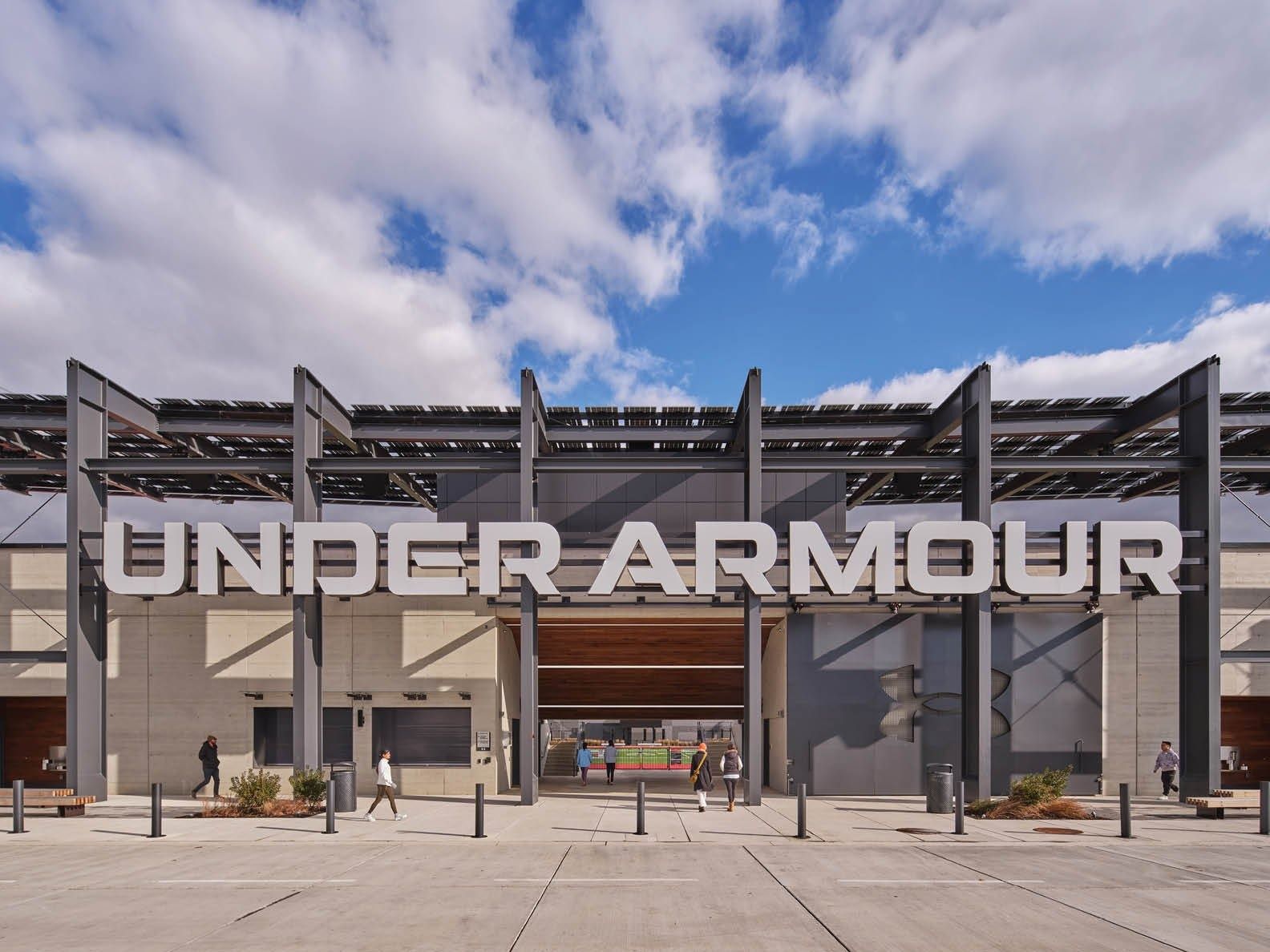 Under Armour: Large Under Armour lettering on a steel entrance structure with solar panels above, plaza in front