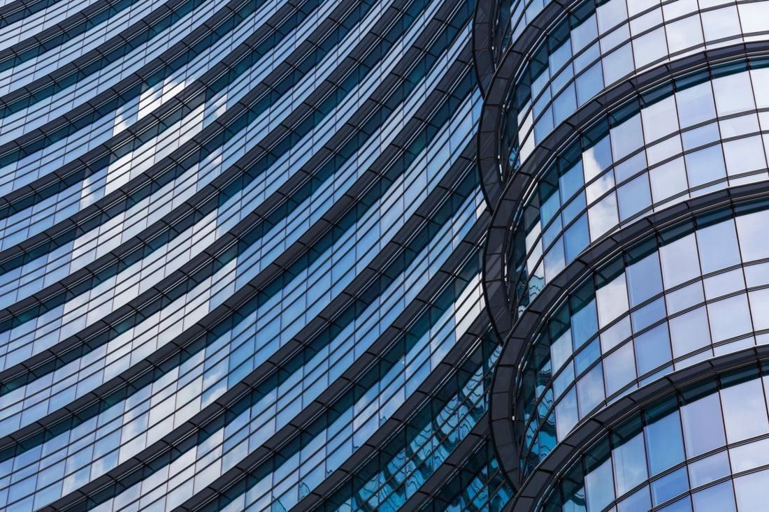UniCredit: Close view of a curved glass facade with horizontal bands
