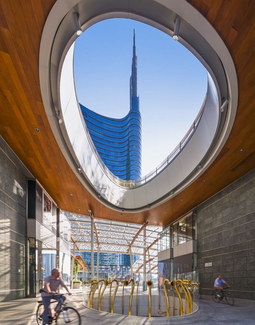 UniCredit: View through an oval opening in a wooden-lined canopy toward the tower spire