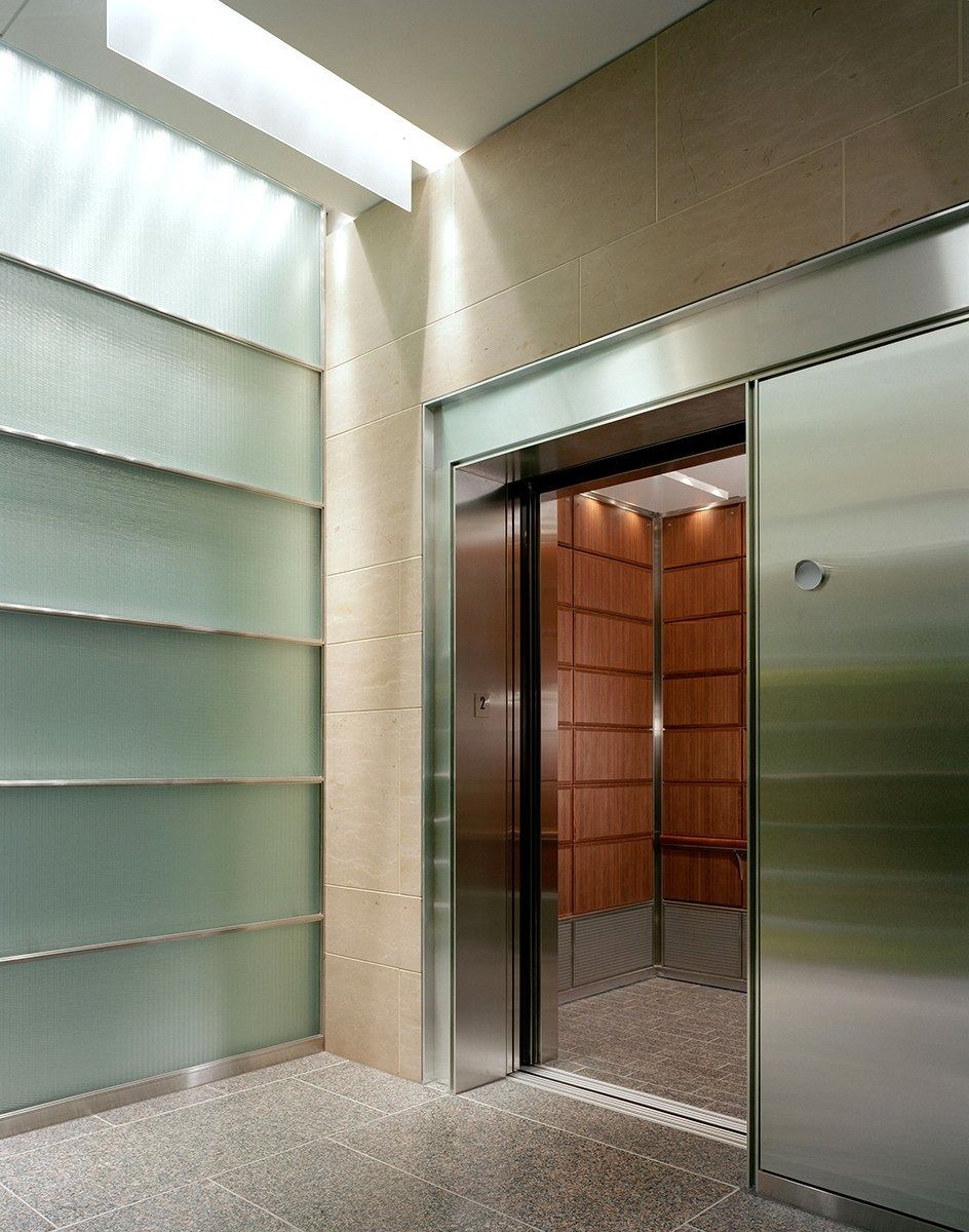 Union Pacific: Elevator lobby with glass panels and a wood-lined elevator