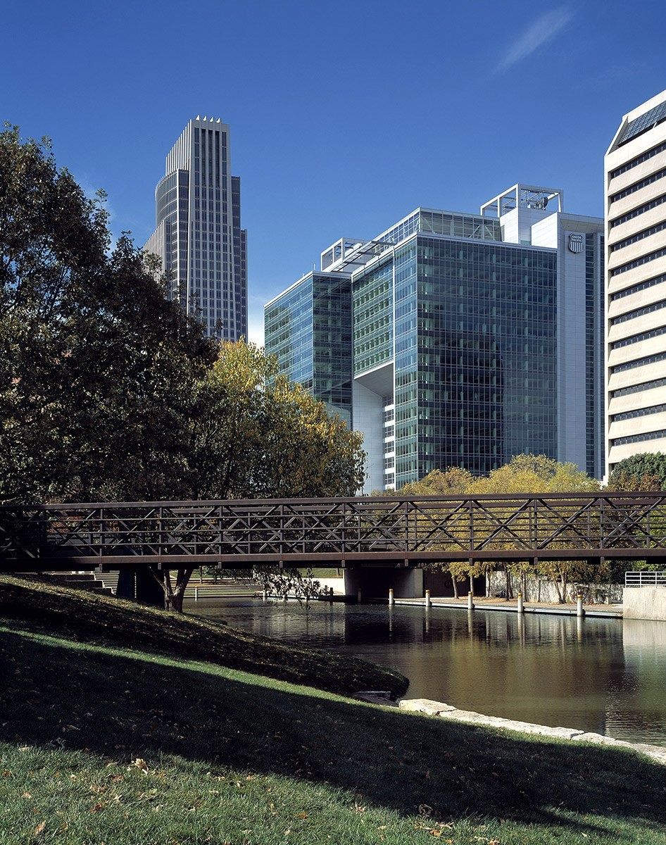 Union Pacific: Glass office building beyond a park, a pond and a footbridge