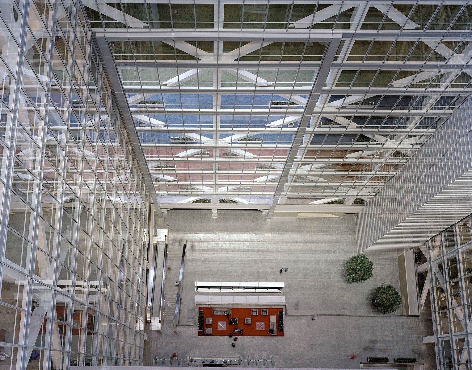 Looking up through a tall atrium to a steel and glass skylight