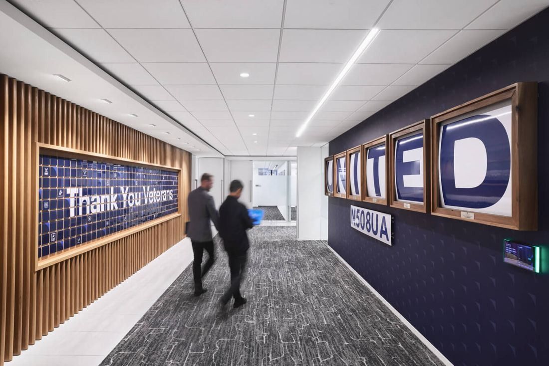 United Airlines: Corridor with large lit letters spelling UNITED and a wall reading Thank You Veterans