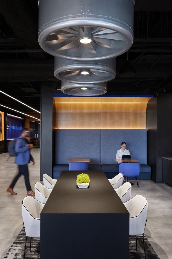 United Airlines: Long meeting table under hanging engine-fan light fixtures
