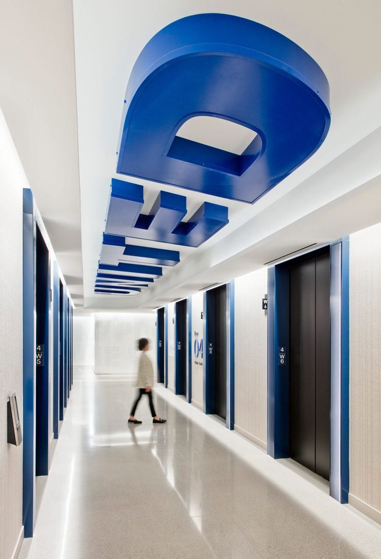 United Airlines: Narrow white corridor with a blue curved form overhead