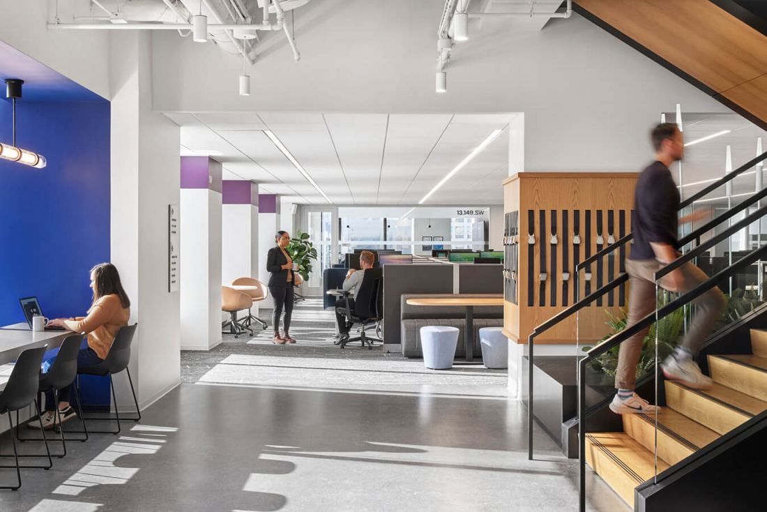 United Airlines: Open office with a wooden interconnecting stair and desks beyond