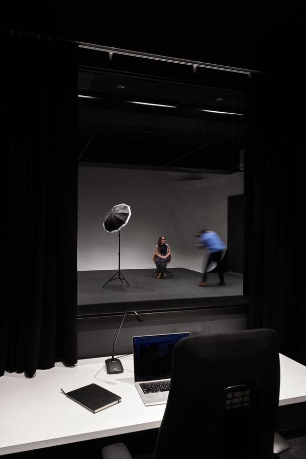 United Airlines: Small dark studio with lighting equipment seen past a desk