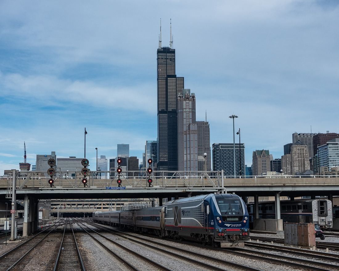 United Airlines: Willis Tower seen beyond rail tracks and a passing train