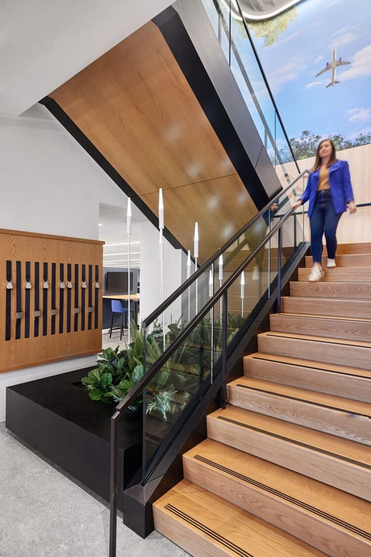United Airlines: Wooden stair with glass balustrade rising between floors