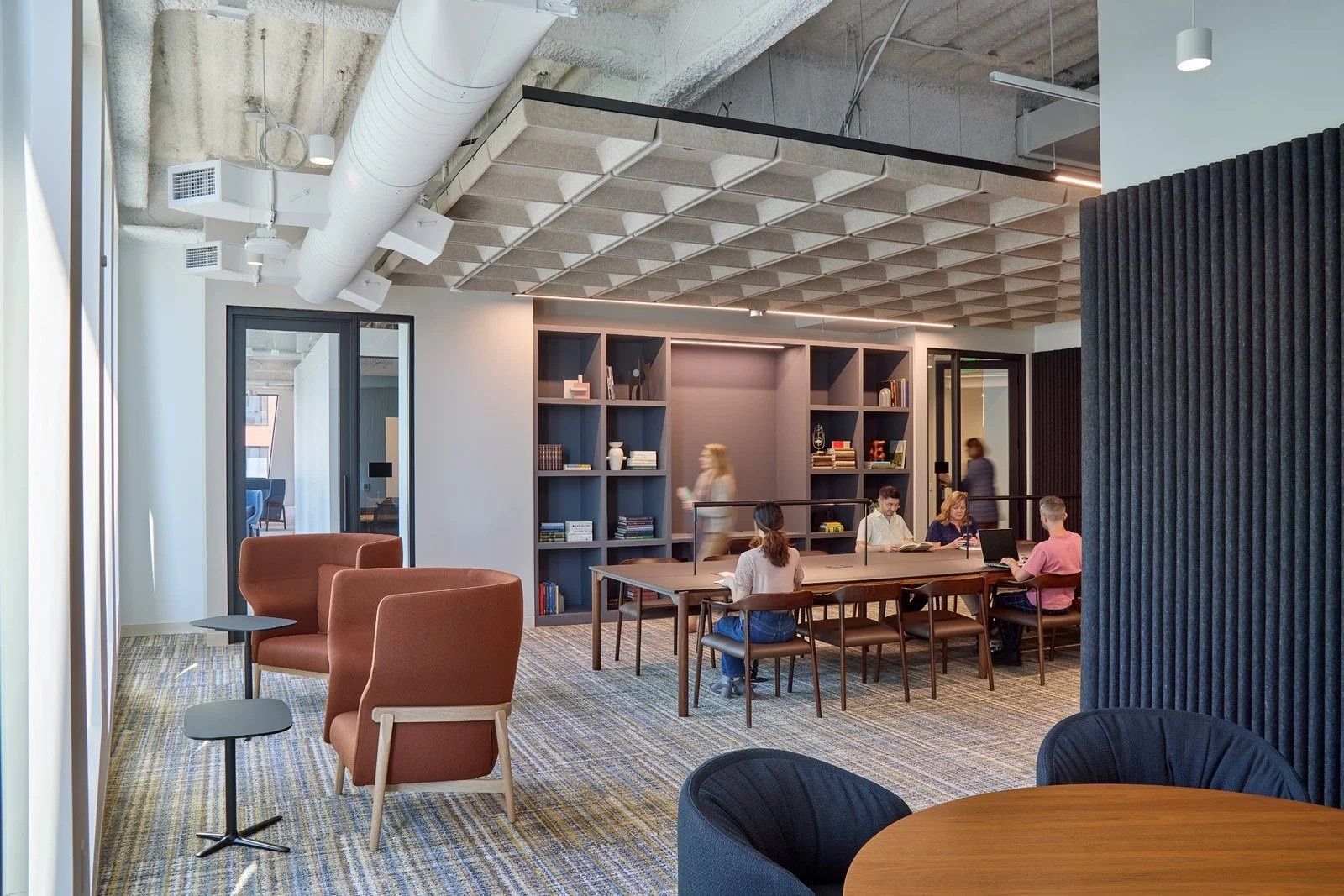 Visa: A library-like lounge with wood panels and armchairs