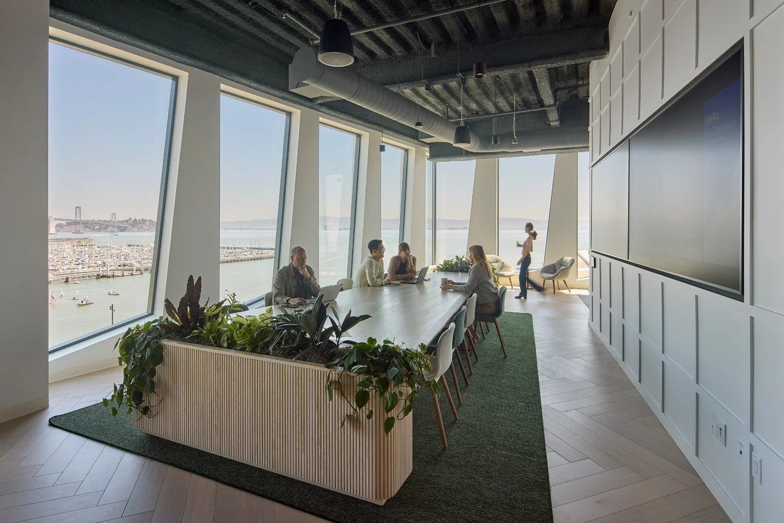 Visa: A long planted work table by windows over the bay