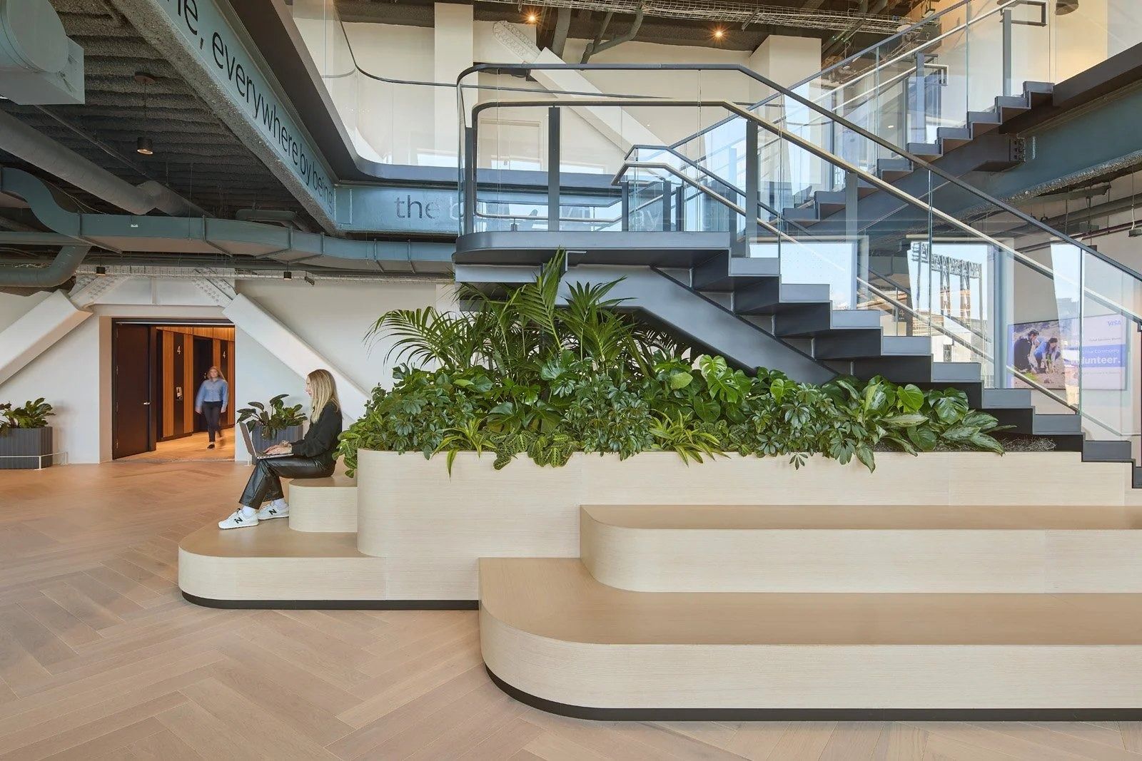 Visa: Tiered seating with plants by a stair