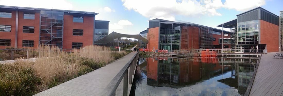 Modern office buildings around a reflecting pond on the Newbury campus