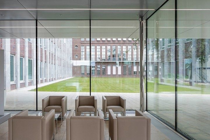 Volkswagen Group: Leather armchairs behind a glass wall facing a lawn