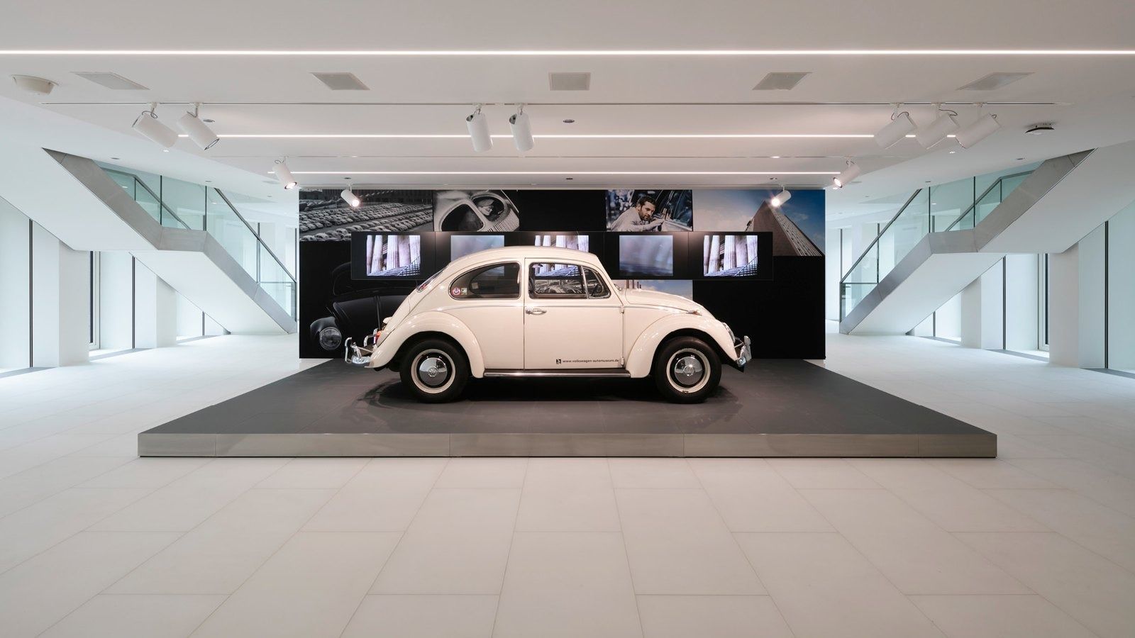 Volkswagen Group: White Beetle on a platform in a bright hall