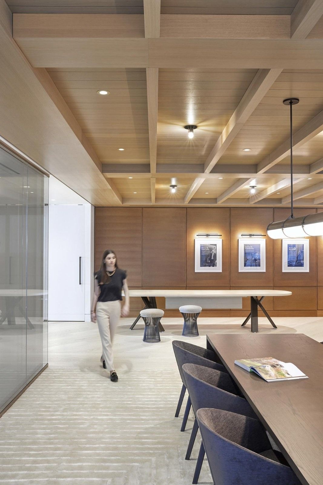 Walker & Dunlop: A corridor with a coffered wood ceiling and framed photos