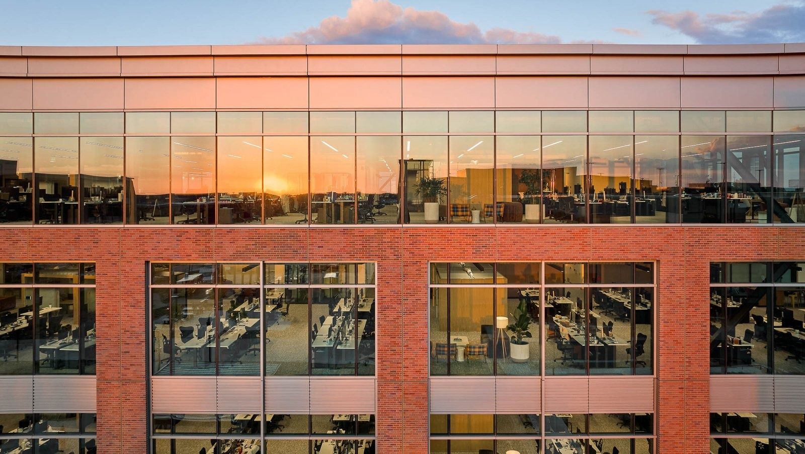Walmart: A brick building with glass upper floors at sunset