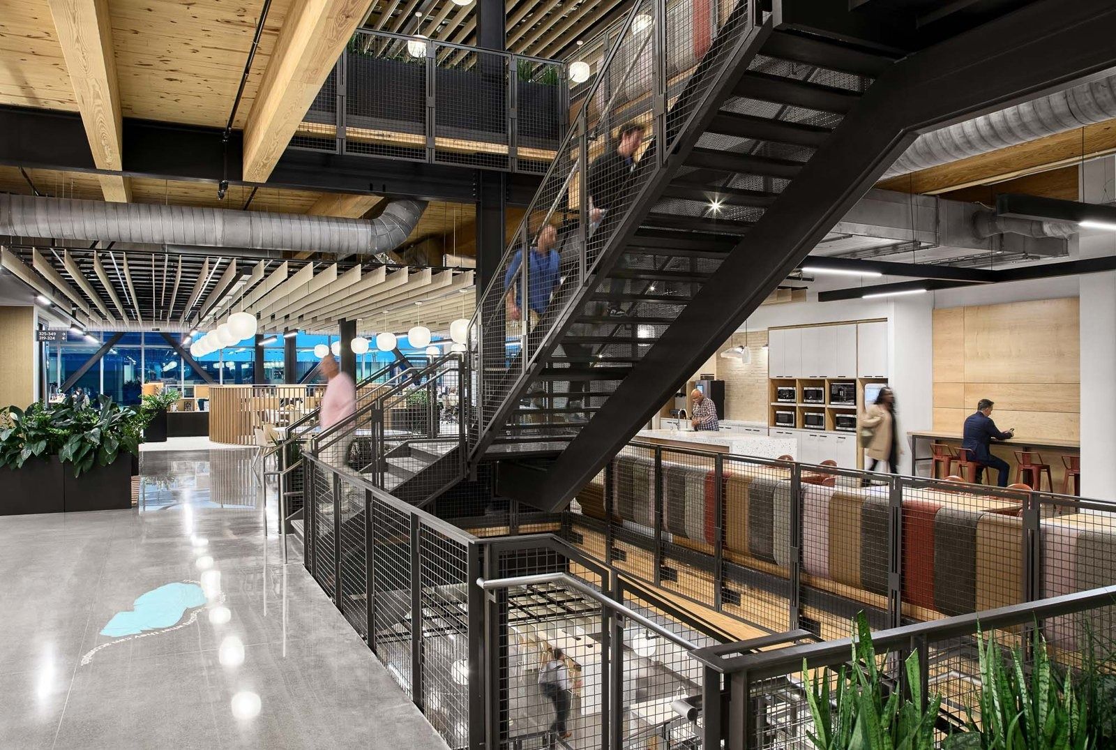 Walmart: A mass-timber interior with a black steel stair