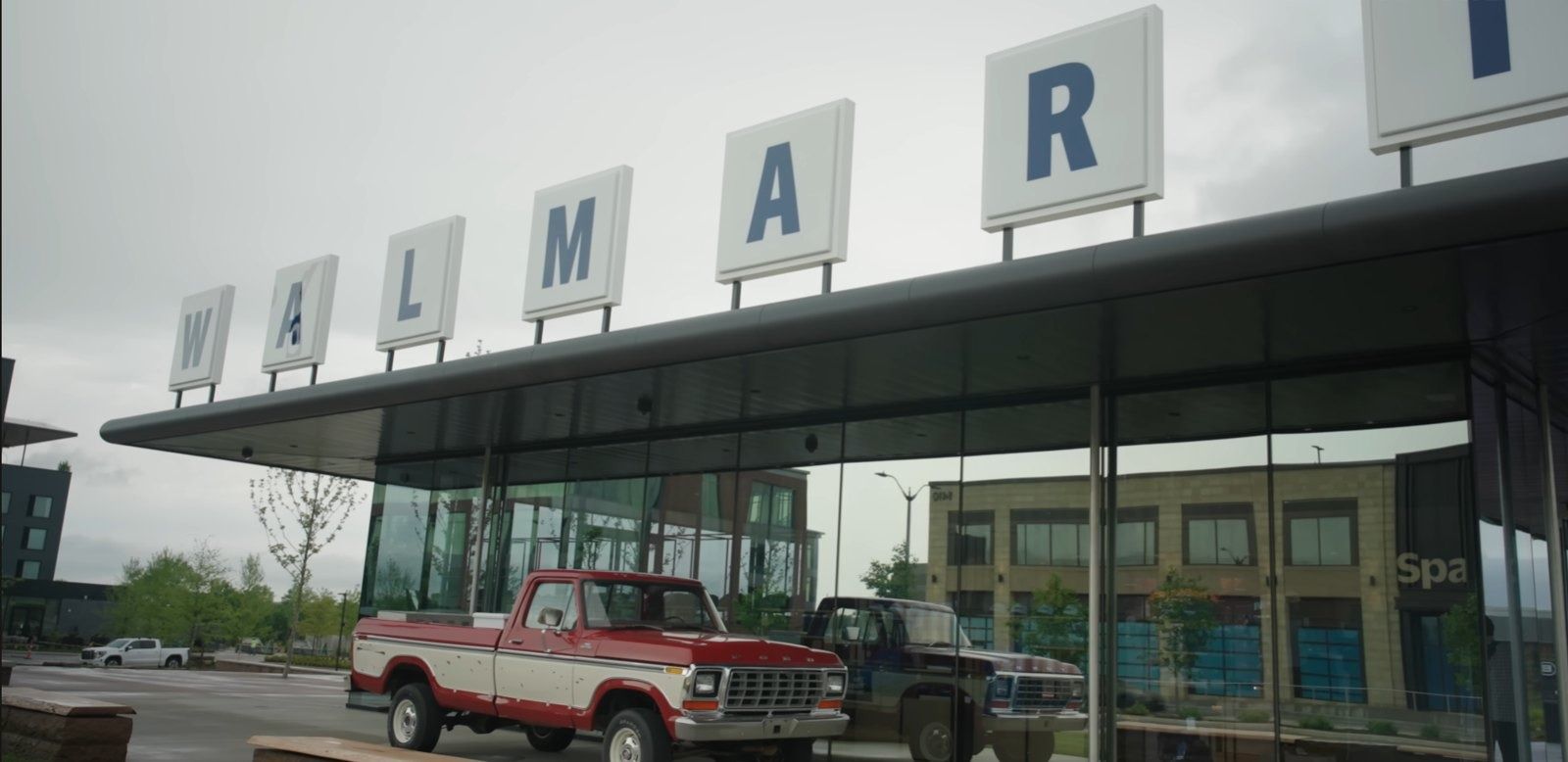 A Walmart sign with a vintage pickup