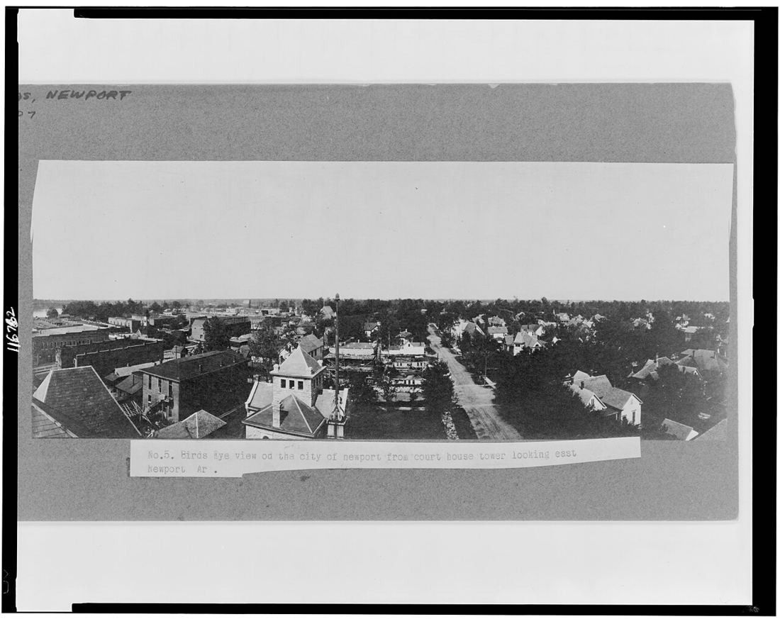 Old black-and-white bird’s-eye view over the rooftops and streets of a small town