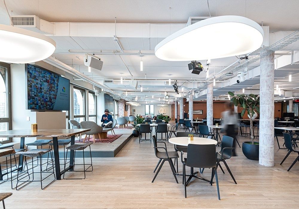 Warner Bros. Discovery: Community space with round ceiling lights