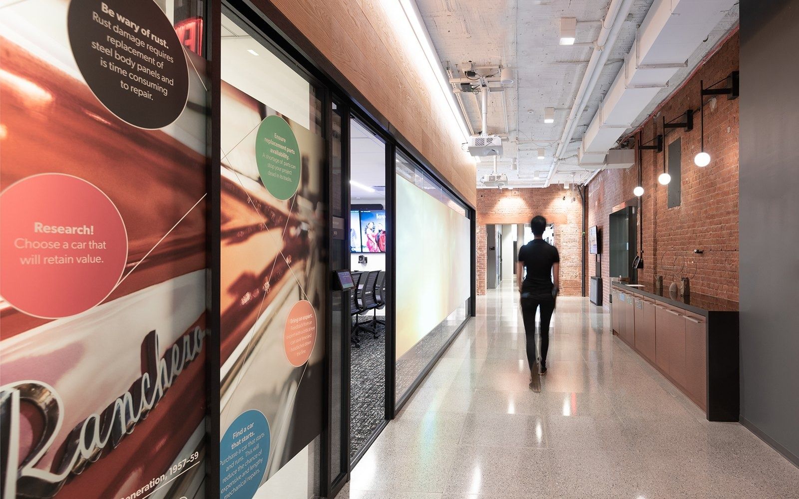 Warner Bros. Discovery: Corridor with brand graphics on glass