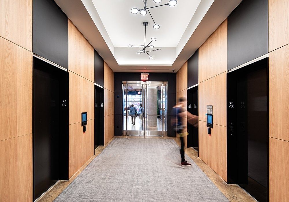 Warner Bros. Discovery: Elevator lobby with timber panels