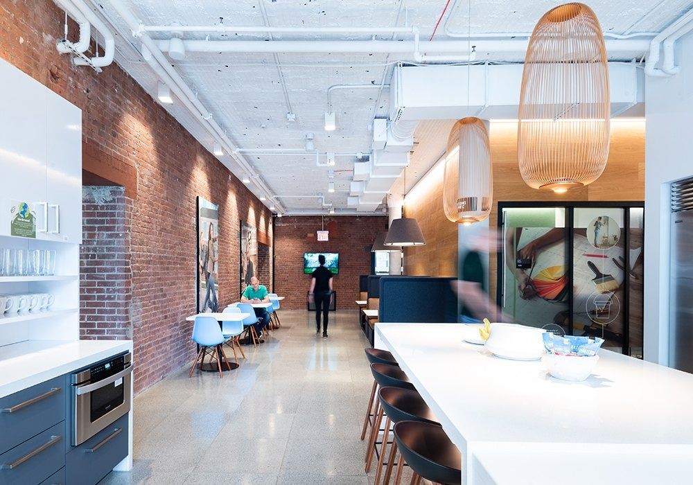 Warner Bros. Discovery: Pantry with long white counters and brick wall