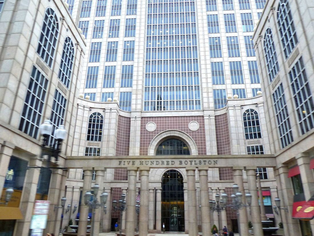 Wayfair: Courtyard view up the stone and glass facade of 500 Boylston with its arched entrance