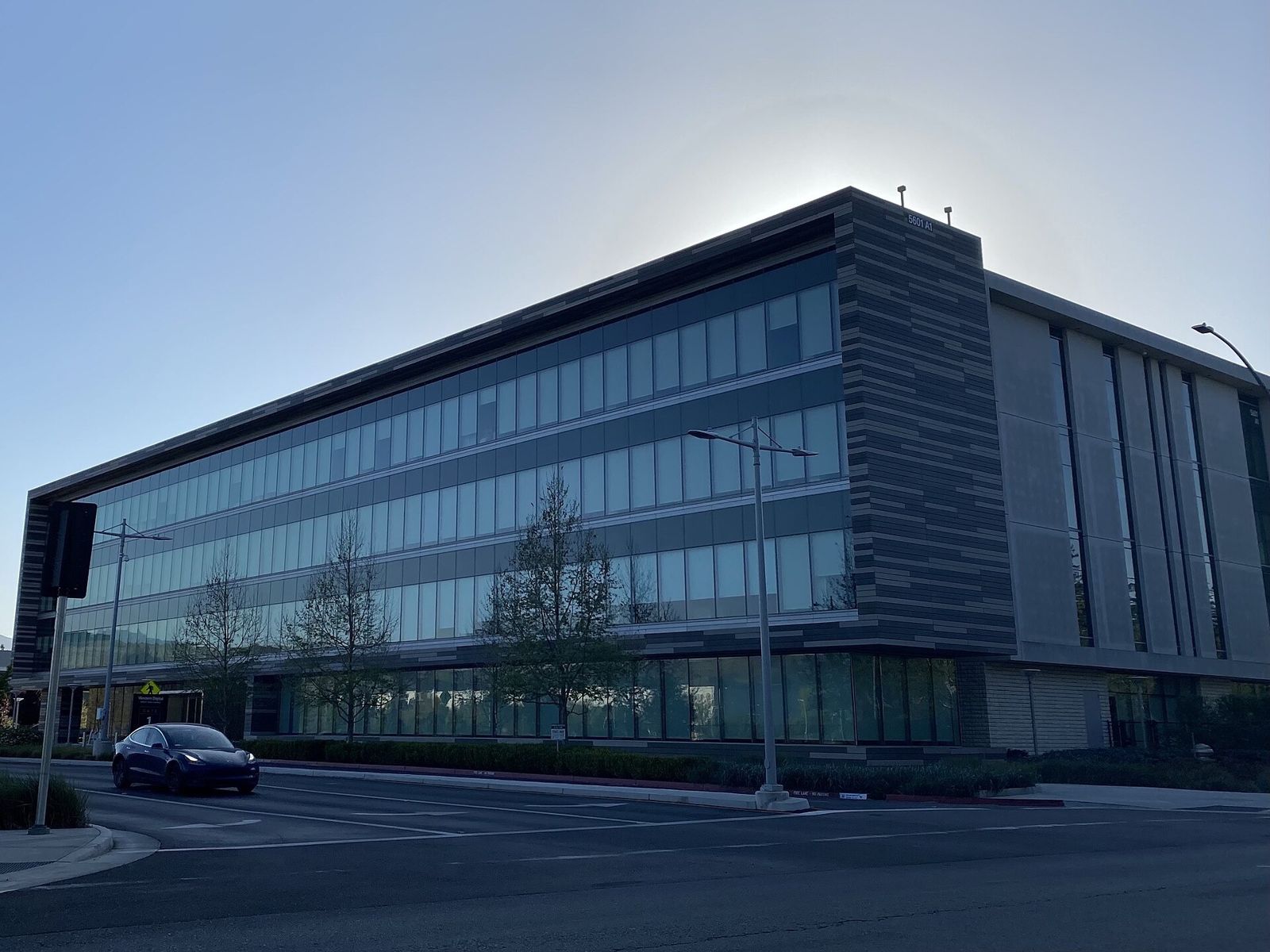 Western Digital: A glass office building on a street corner in low morning sun