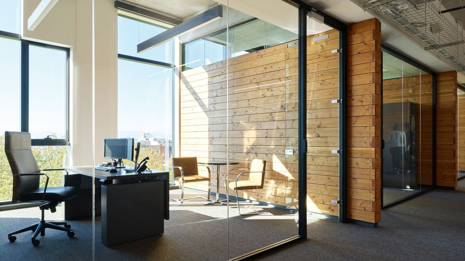 Weyerhaeuser: Glass-walled private office next to a wall of reclaimed wood