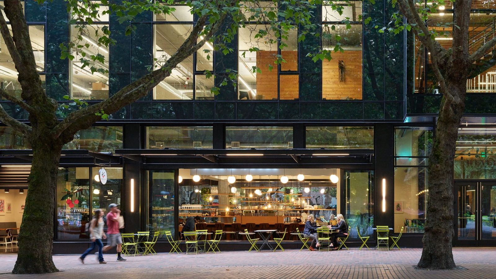 Weyerhaeuser: Ground-floor café with people at tables under trees