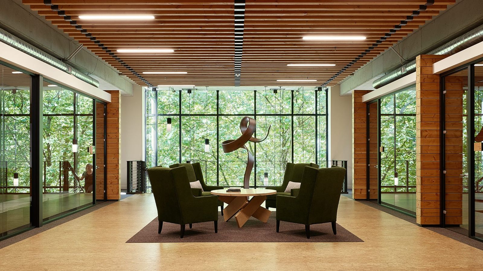 Weyerhaeuser: Lounge with armchairs in front of windows full of trees