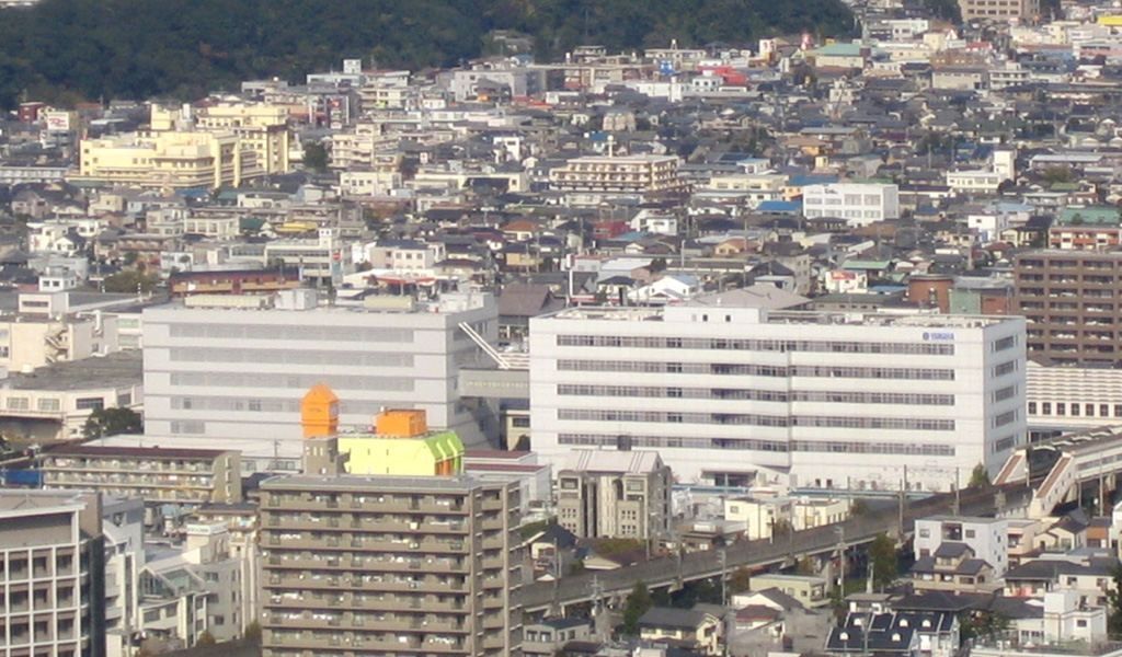 Yamaha: White headquarters buildings among dense city blocks, seen from a distance
