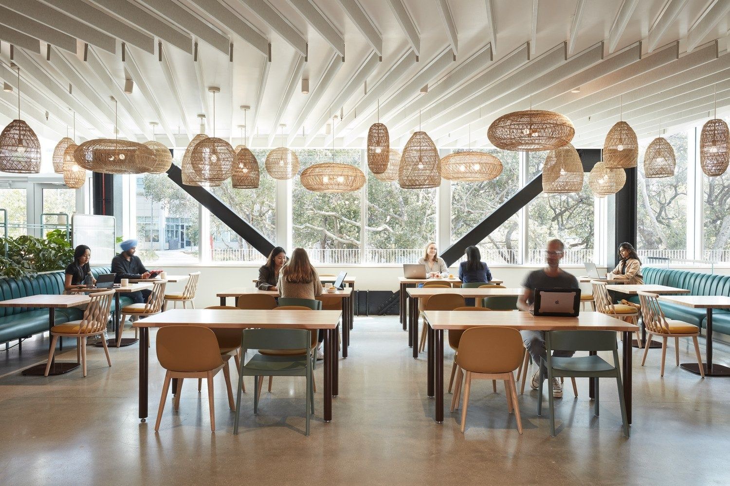 YouTube: Café with rows of wooden tables, woven pendant lamps and large windows onto trees