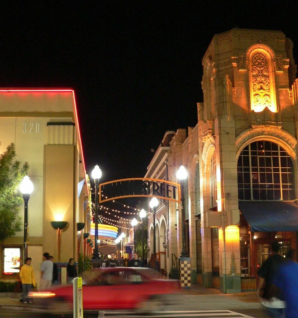 Downtown street at night with a lit Art Deco facade