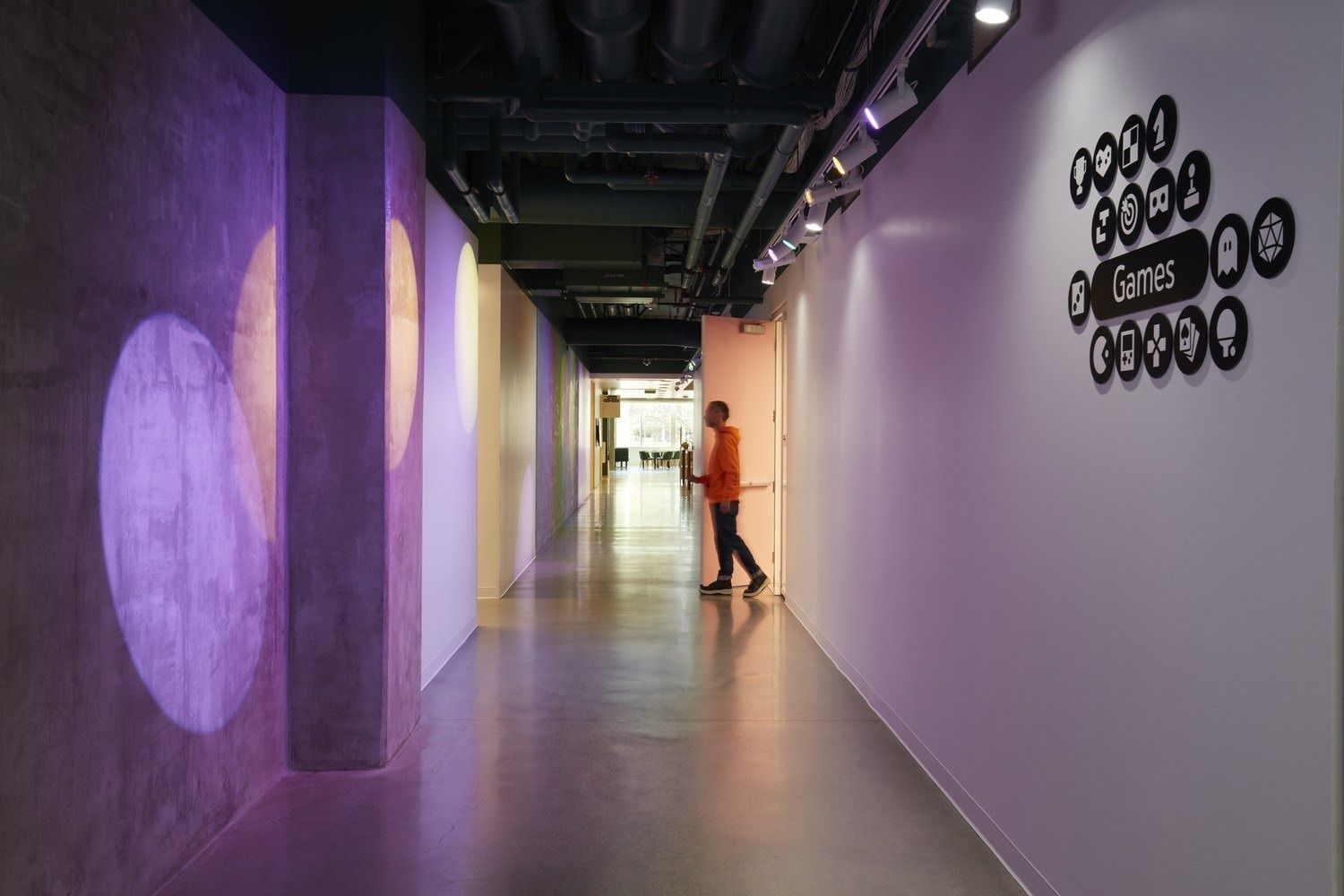 YouTube: Long corridor with purple walls and a graphic sign reading Games