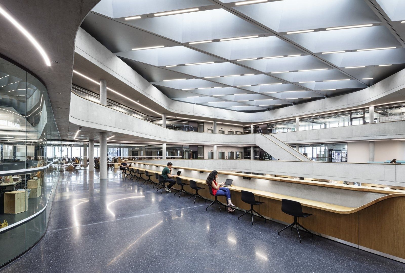 Zalando: Gallery level with a long wooden counter and curved ceiling lights
