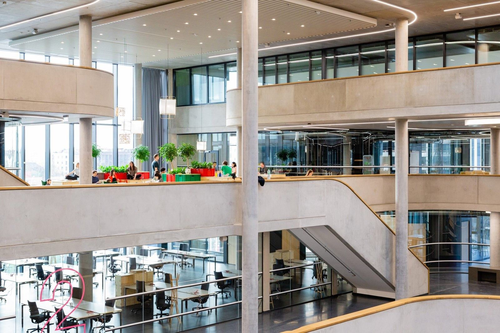 Zalando: Multi-storey concrete atrium with stairs, balconies and plants seen across the floors