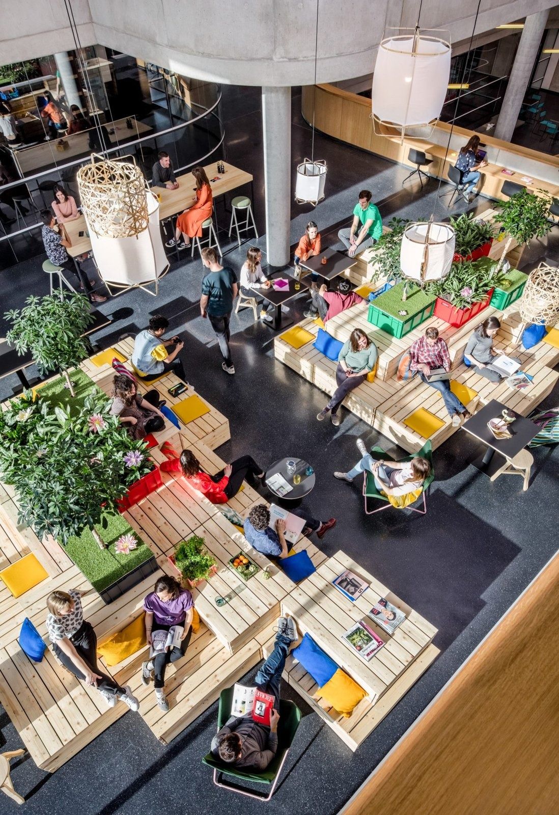 Zalando: Top-down view of a busy lounge with wooden seating and plants