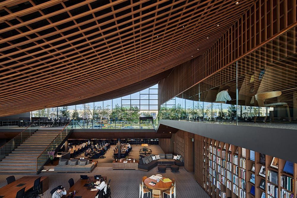ZOZO: View down into a multi-level workspace with bookshelves, lounges and stairs